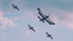 Old airplanes flying with blue sky on the background